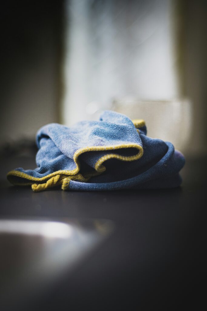 A blue and yellow rag on a black surface.